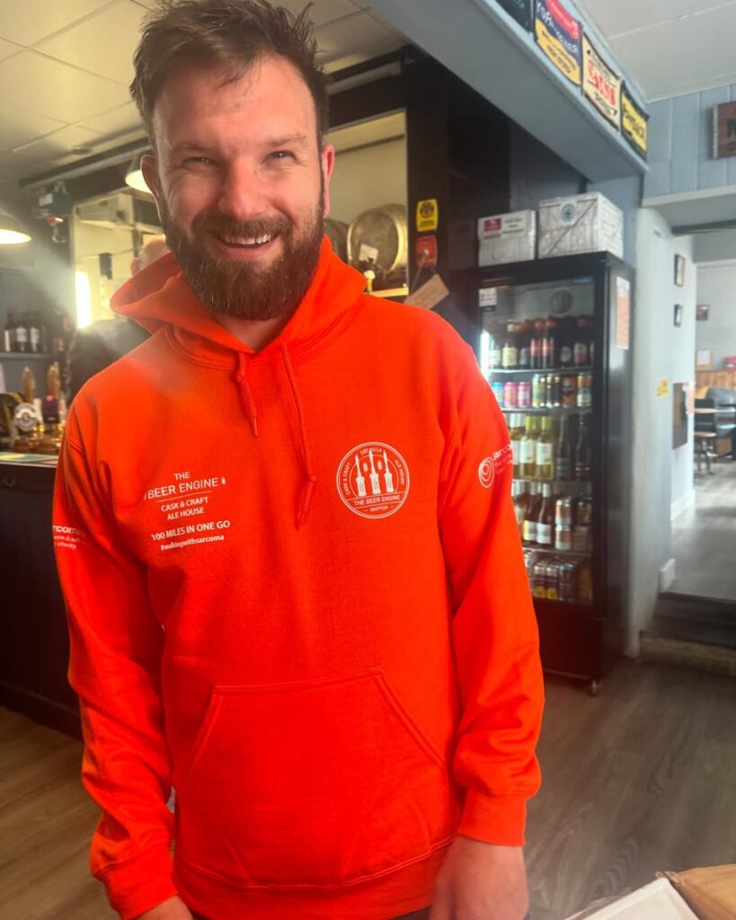 The Beer Engine x J Mitchell Design 5 Staff member wearing The Beer Engine Skipton branded hoodie inside the micropub
