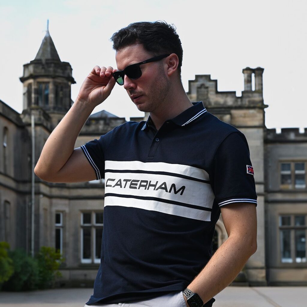 Caterham branded polo shirt modelled outside heritage building, designed by J Mitchell