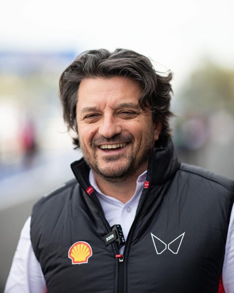 mahindra racing motorsport sportswear gilet 1 Mahindra Racing team member wearing a black gilet with Shell and butterfly logo, designed by Jonathan Mitchell