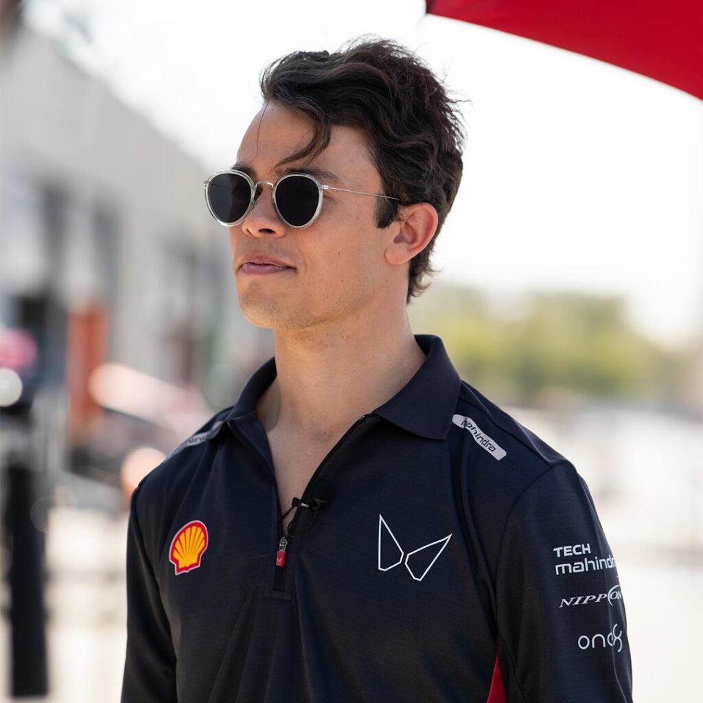 Mahindra Racing Technical Polo Shirt – Race Day Style Mahindra Formula E team member wearing a black branded technical polo shirt with Shell and Tech Mahindra logos