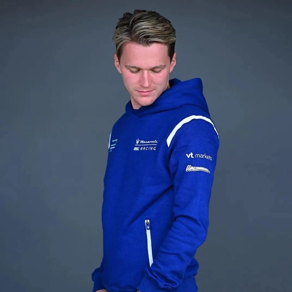 Maserati Racing – Branded Sportswear Hoodie Model looking down wearing a blue Maserati MSG Racing hoodie