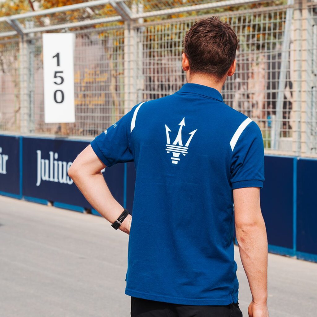 Maserati MSG Racing Trackside Teamwear Maserati MSG Racing staff member wearing blue polo shirt with trident logo during Formula E event