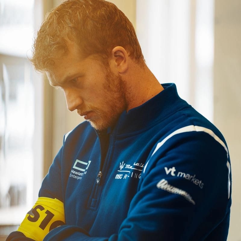 Maserati MSG Racing – Technical Q-Zip Garment Close-up of Maserati Racing team member in blue quarter zip with VT Markets and Hewlett Packard logos