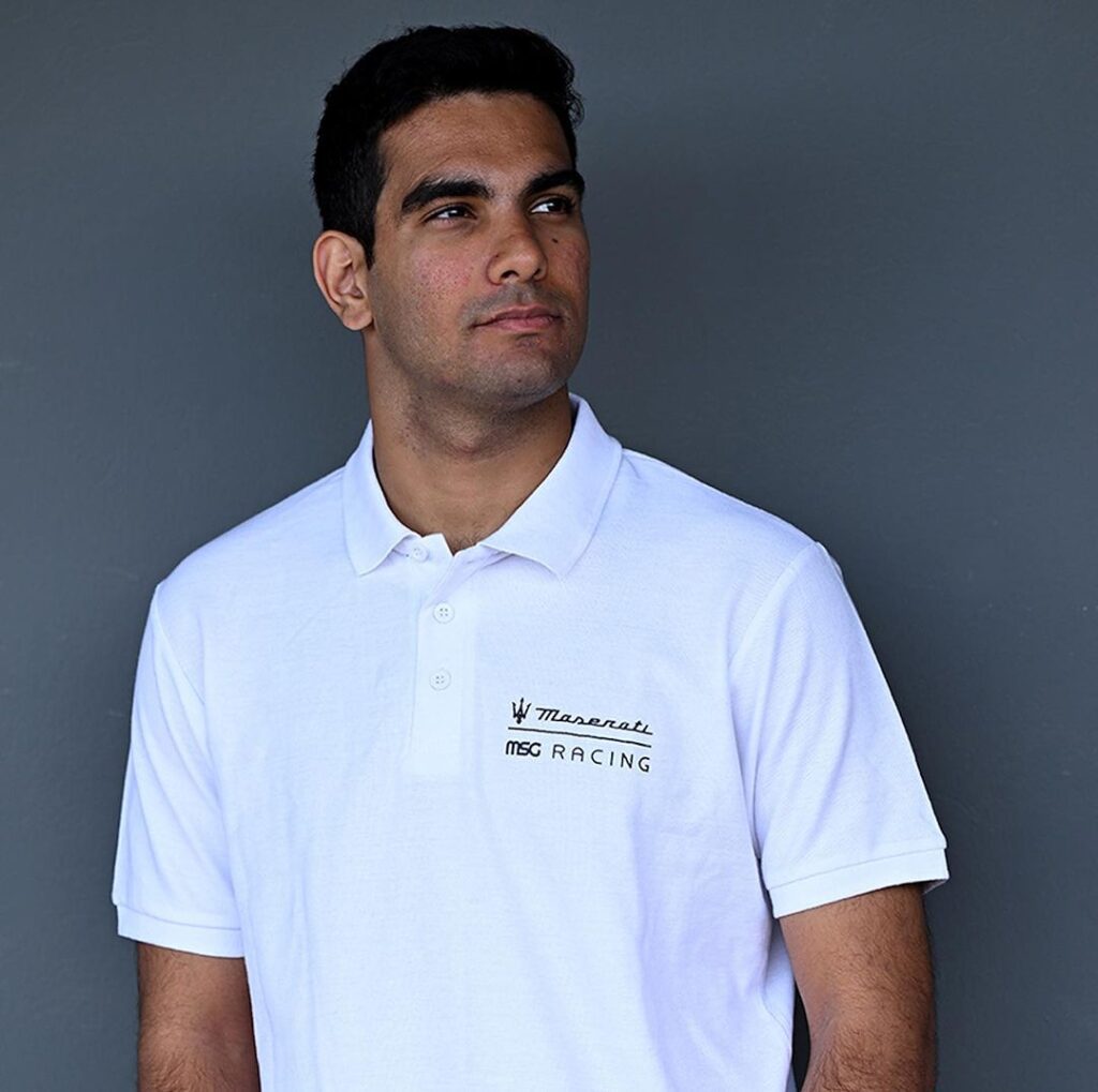 Maserati motorsport white polo shirt front view Model wearing front view of Maserati MSG Racing branded white polo shirt