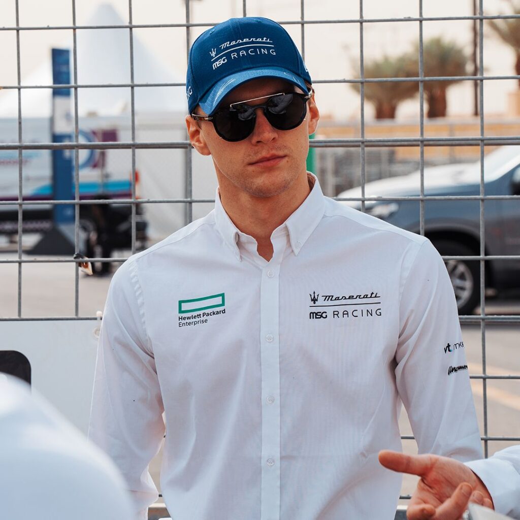 Maserati motorsport white shirt close-up Close-up of Maserati MSG Racing white shirt with logos and blue cap