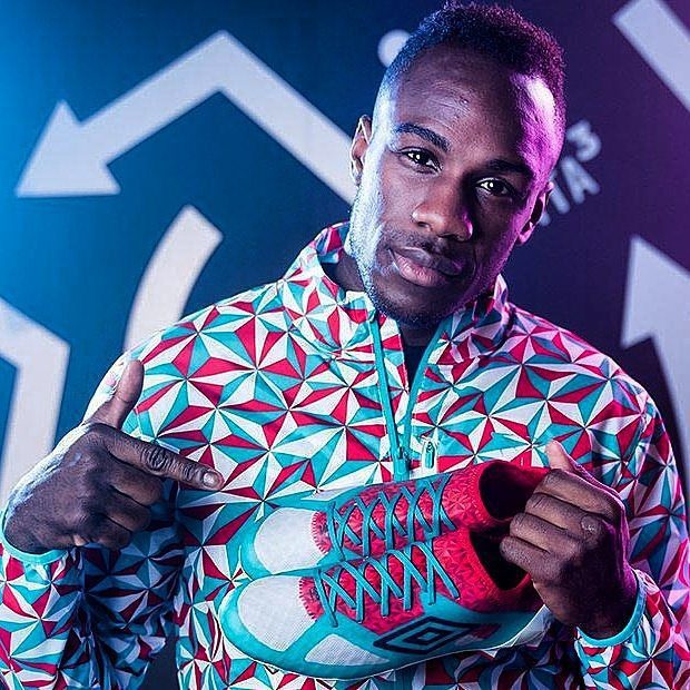 umbro-manchester-football-sportswear-designer-michail-antonio Michail Antonio holding Umbro boots in geometric-pattern jacket designed by J Mitchell for Umbro