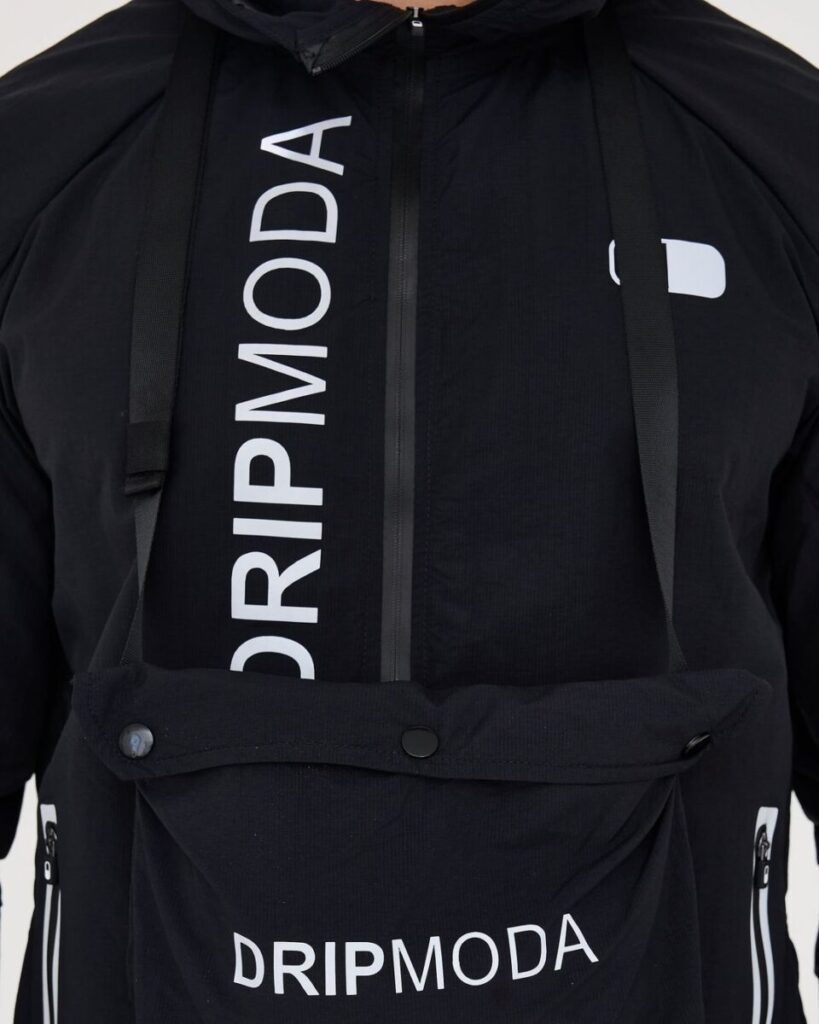 Dripmoda jacket detail fashion designer uk Close-up of Dripmoda windbreaker jacket branding and drawcords